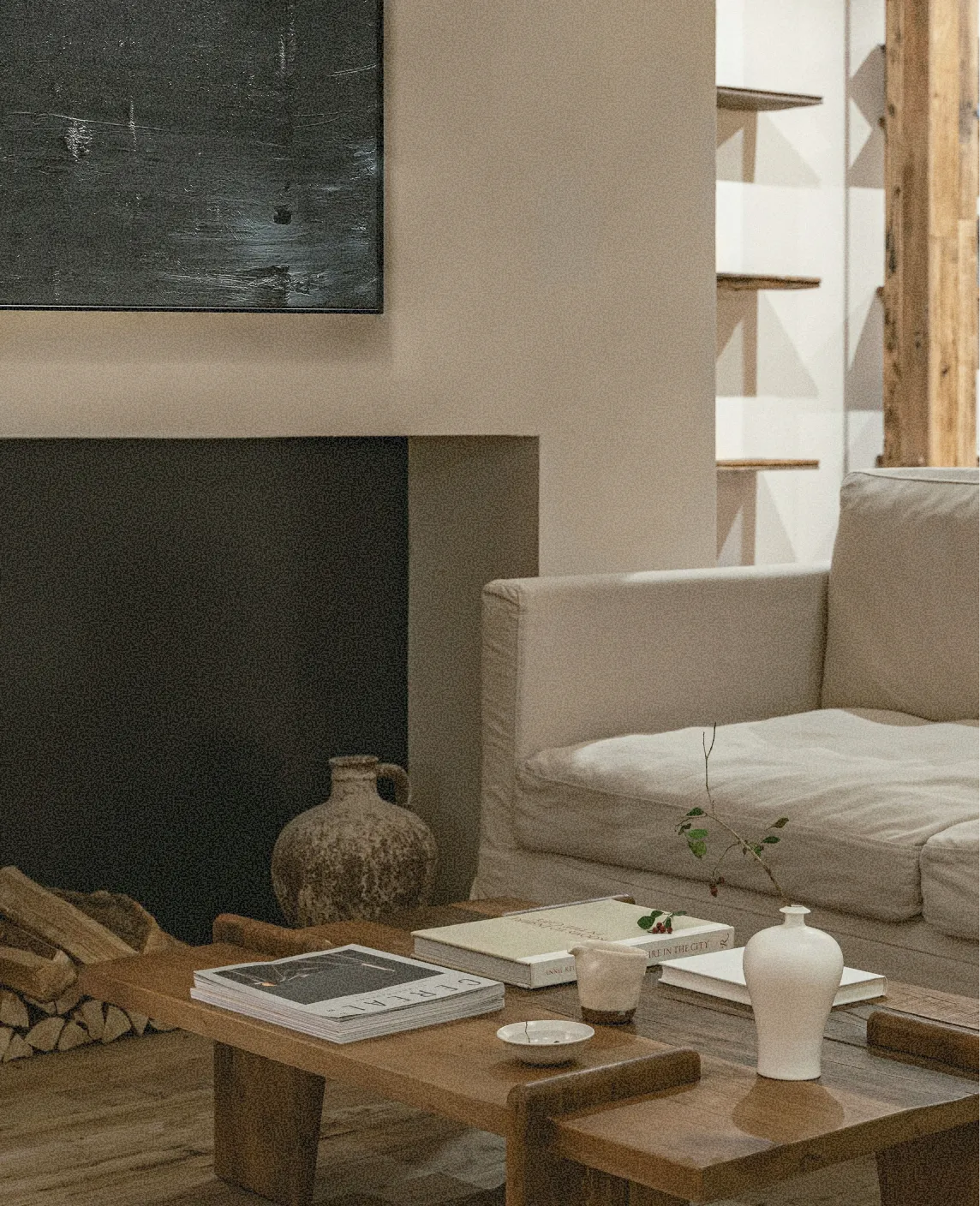 Fireplace nook with a linen sofa and low timber coffee table